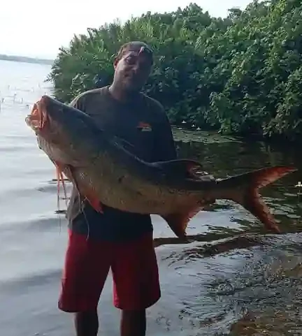 Pêcheur présentant un capitaine de belle taille dans la lagune d’Iguéla